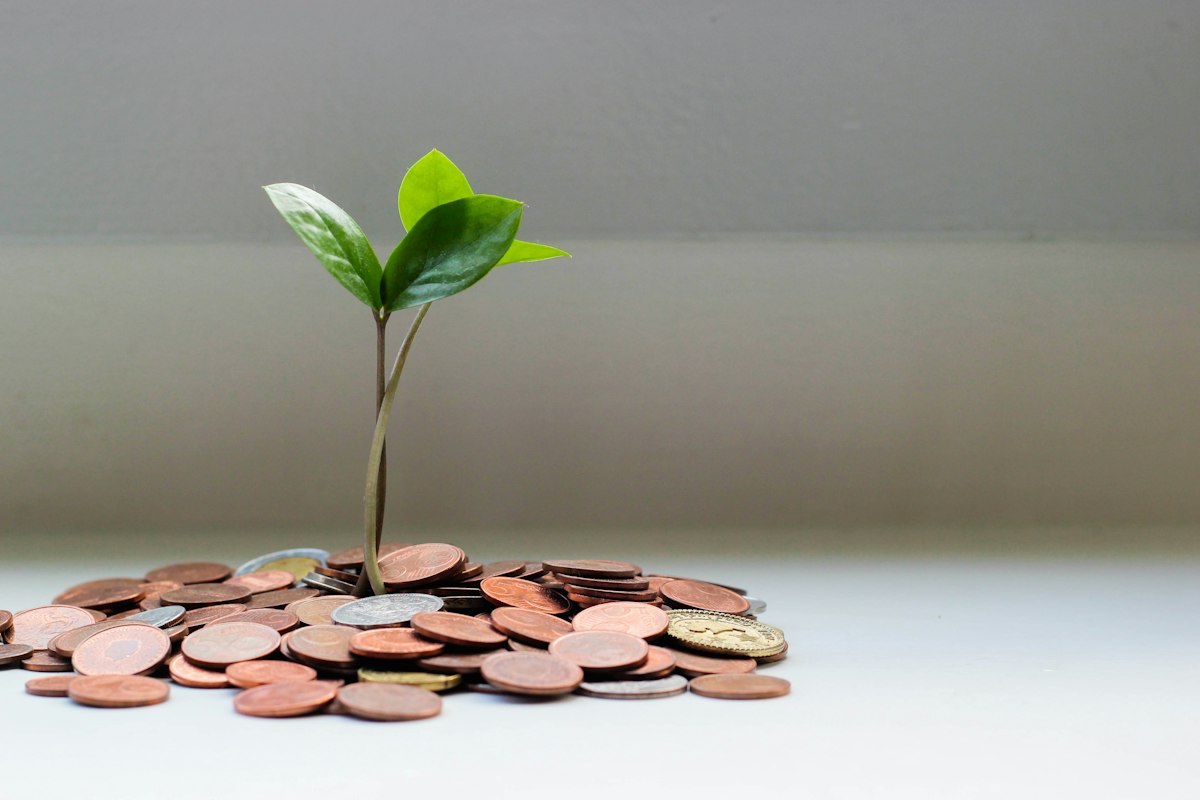 Coins stacked beside a notepad listing monthly budget categories